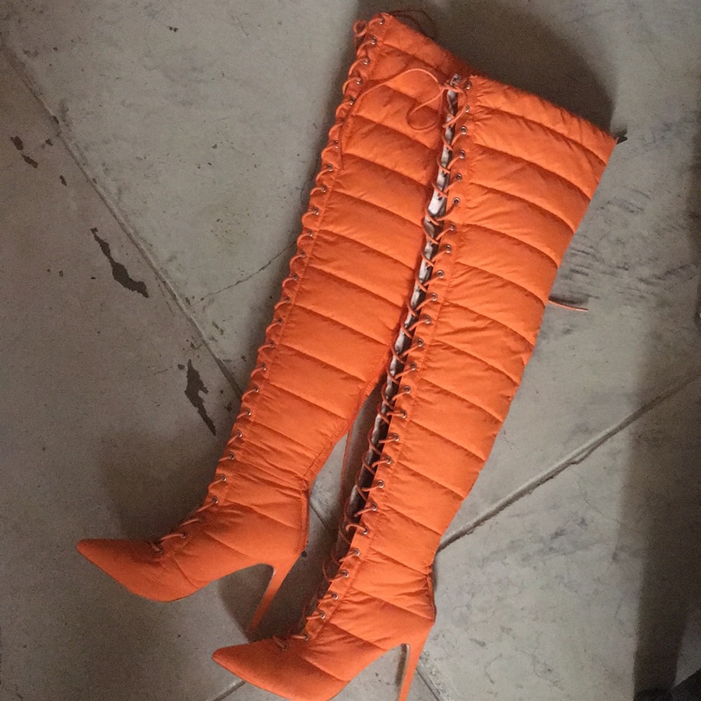 Orange puffer over the knee boots